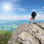 Man on peak of mountain